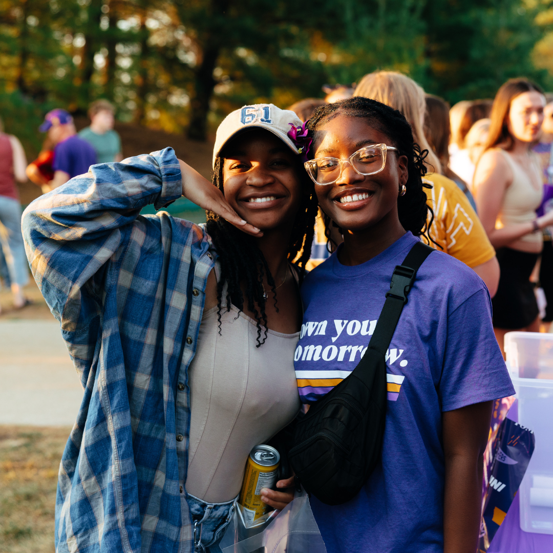 Two UNI students smiling at the camera.