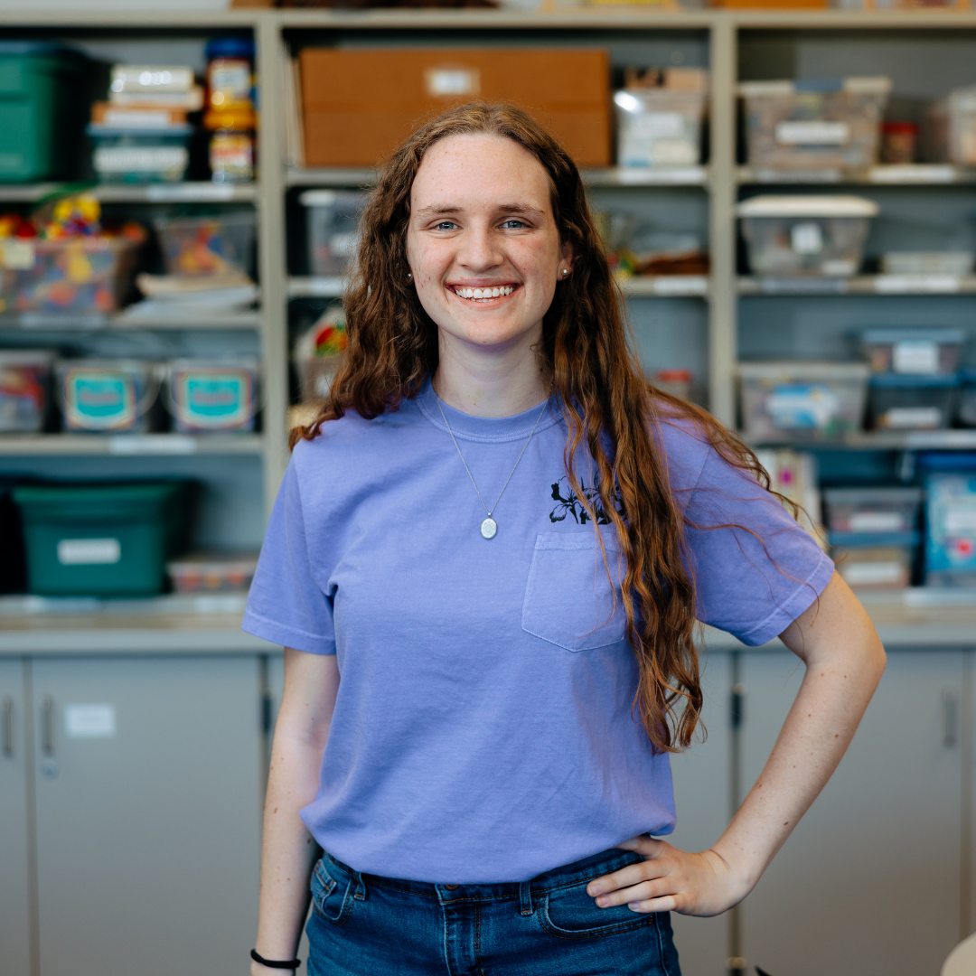 Student in a purple shirt standing