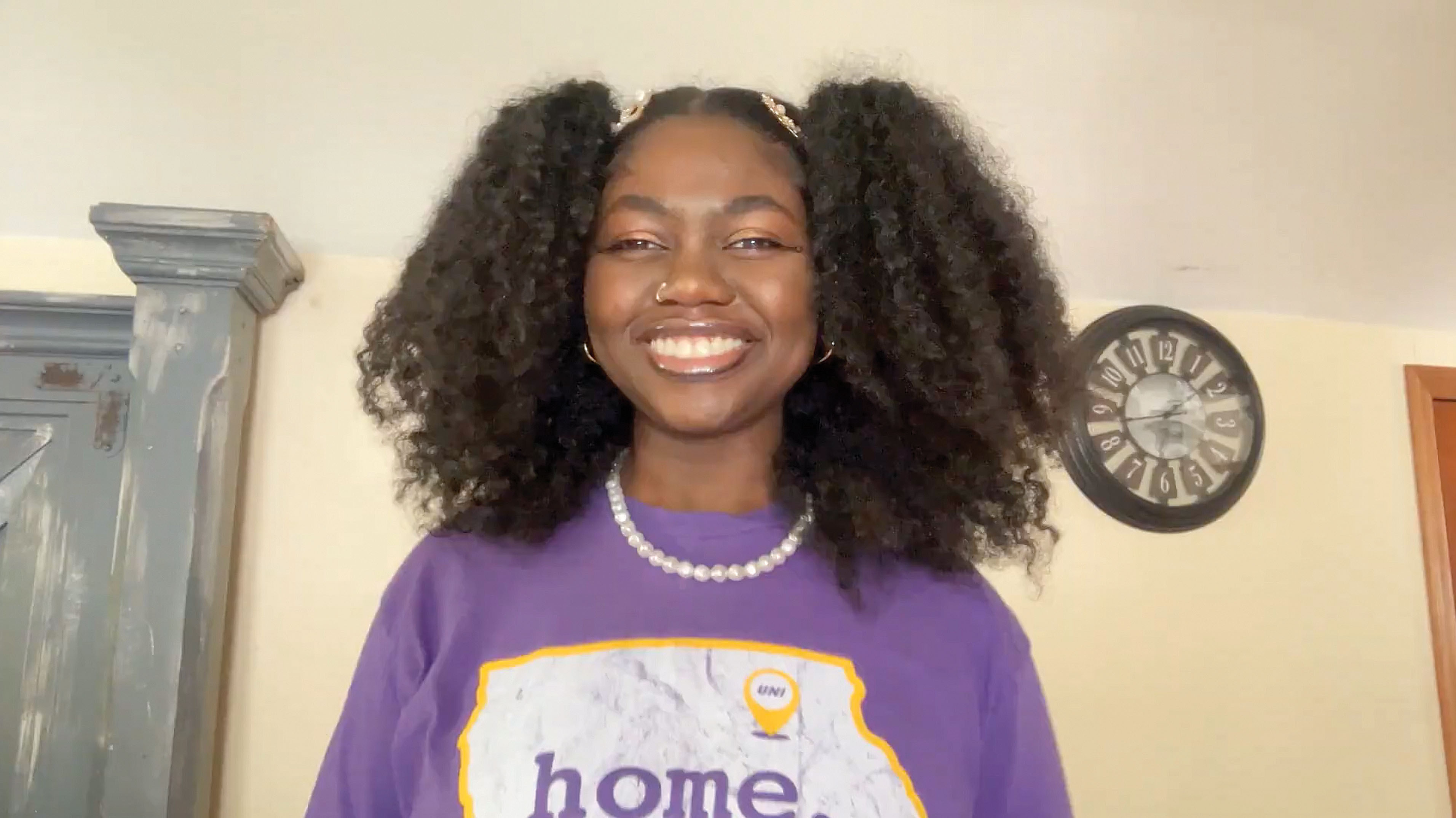 Destiny Dixon smiling and wearing purple UNI "home" t-shirt