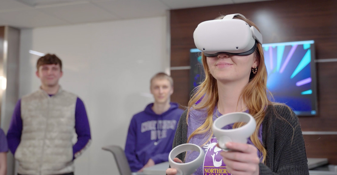 UNI student learning with a VR headset in the Wilson College of Business