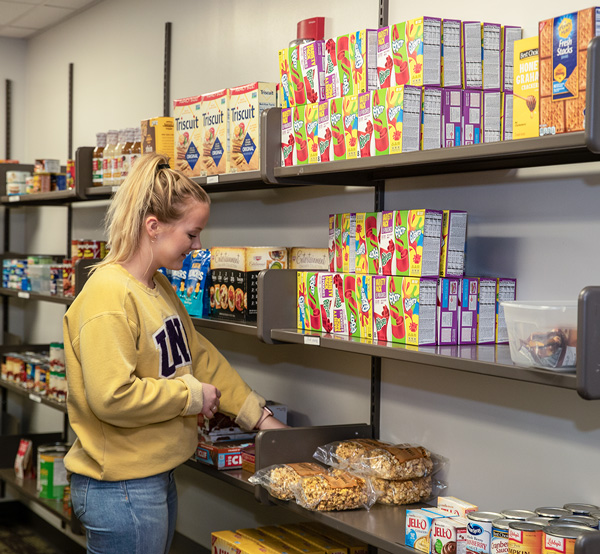 UNI student looking through food at the Panther Pantry